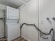 Laundry room with a stacked washer and dryer and ample storage space at 10392 W Deanne Dr, Sun City, AZ 85351