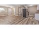 Open-concept living space with vinyl flooring adjacent to the kitchen that has stainless steel appliances at 10392 W Deanne Dr, Sun City, AZ 85351