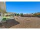 View of covered patio and hardscaped backyard with mature trees at 10509 W Oak Ridge Dr, Sun City, AZ 85351