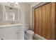 Clean bathroom with white vanity, framed mirror, and shower/tub combo behind a neutral curtain at 10509 W Oak Ridge Dr, Sun City, AZ 85351