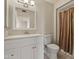 Clean bathroom with white vanity, framed mirror, and shower/tub combo behind a neutral curtain at 10509 W Oak Ridge Dr, Sun City, AZ 85351