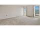 Bright, carpeted bedroom featuring two windows with blinds and neutral paint at 10509 W Oak Ridge Dr, Sun City, AZ 85351