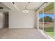 Bright dining area with tiled floor, chandelier and sliding glass doors to the backyard at 10509 W Oak Ridge Dr, Sun City, AZ 85351