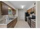 Classic kitchen with wood cabinets, stainless steel sink and neutral countertops at 10509 W Oak Ridge Dr, Sun City, AZ 85351