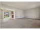 Open living space with carpet, neutral walls and sliding glass doors to the backyard at 10509 W Oak Ridge Dr, Sun City, AZ 85351