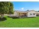 Expansive backyard with lush green lawn and a patio area, ideal for entertaining at 10611 W Camelot Cir, Sun City, AZ 85351