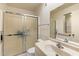 Bathroom featuring a glass-enclosed shower, well-lit vanity, and a functional layout at 10611 W Camelot Cir, Sun City, AZ 85351