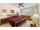 A cozy bedroom with wood furniture, carpet, and a ceiling fan at 10611 W Camelot Cir, Sun City, AZ 85351