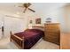 Cozy bedroom with plush carpet, a double bed, and natural light streaming through the windows at 10611 W Camelot Cir, Sun City, AZ 85351