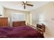 Bright bedroom with neutral walls, dresser, and a ceiling fan for added comfort at 10611 W Camelot Cir, Sun City, AZ 85351