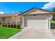 A well-maintained single-story home with a two-car garage, beautiful landscaping, and a welcoming facade at 10611 W Camelot Cir, Sun City, AZ 85351