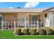 Inviting front porch area with decorative fence, potted plants, and a cozy seating arrangement for relaxing at 10611 W Camelot Cir, Sun City, AZ 85351