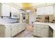 A cozy kitchen featuring white cabinetry and a tiled backsplash at 10611 W Camelot Cir, Sun City, AZ 85351