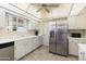 Bright kitchen featuring white cabinets, stainless steel appliances and a tiled floor at 10611 W Camelot Cir, Sun City, AZ 85351