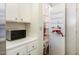 A well-organized pantry with shelves and hanging storage solutions at 10611 W Camelot Cir, Sun City, AZ 85351