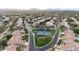 Neighborhood aerial view featuring tennis courts, lush landscaping, well-maintained homes, and curving residential streets at 11256 E Palomino Rd, Scottsdale, AZ 85259