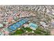 Wide aerial shot of a community showcasing tennis courts, a community pool, lush greenery, and organized residential streets at 11256 E Palomino Rd, Scottsdale, AZ 85259