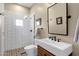 A charming bathroom featuring white subway tile in the shower and patterned tile flooring beneath the toilet and sink at 11256 E Palomino Rd, Scottsdale, AZ 85259