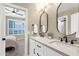 Bright bathroom with double sinks, modern fixtures, and stylish lighting reflected in the mirror at 11256 E Palomino Rd, Scottsdale, AZ 85259