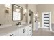 Elegant bathroom with double sinks, modern fixtures, and stylish lighting reflected in the mirror at 11256 E Palomino Rd, Scottsdale, AZ 85259