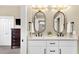 Spacious bathroom with double sinks, modern lighting, and a view into the bedroom at 11256 E Palomino Rd, Scottsdale, AZ 85259