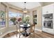 Charming dining area with natural lighting, a modern chandelier, and views of the pool and backyard at 11256 E Palomino Rd, Scottsdale, AZ 85259