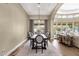 Formal dining room adjacent to living area featuring a large table and stylish decor at 11256 E Palomino Rd, Scottsdale, AZ 85259