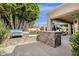 Built-in outdoor grill and bar area, perfect for entertaining with a view of the pool at 11256 E Palomino Rd, Scottsdale, AZ 85259