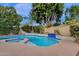 Backyard pool and spa surrounded by mature landscaping and a waterfall feature at 11256 E Palomino Rd, Scottsdale, AZ 85259