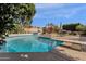 Inviting backyard pool with diving board, waterfall feature, and ample seating area at 11256 E Palomino Rd, Scottsdale, AZ 85259