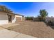 Spacious backyard featuring a two car garage and a clear blue sky at 113 W Rawhide Ave, Gilbert, AZ 85233