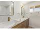 Bathroom vanity with double sinks, modern faucets, marble countertops, and framed mirrors at 113 W Rawhide Ave, Gilbert, AZ 85233