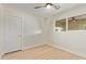 A bedroom with wood-look floors, ceiling fan, one window, and white painted walls at 113 W Rawhide Ave, Gilbert, AZ 85233