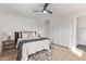 Inviting bedroom featuring neutral décor, a ceiling fan, ample closet space, and modern flooring at 113 W Rawhide Ave, Gilbert, AZ 85233