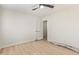 A bedroom with wood-look floors, a ceiling fan, two windows, and white painted walls at 113 W Rawhide Ave, Gilbert, AZ 85233