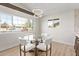 Bright dining room with an elegant chandelier and view to the neighborhood at 113 W Rawhide Ave, Gilbert, AZ 85233