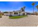 Rear view of a single-story stucco home featuring low-maintenance landscaping, and a detached garage at 113 W Rawhide Ave, Gilbert, AZ 85233