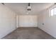 Empty two car garage featuring a white brick wall at 113 W Rawhide Ave, Gilbert, AZ 85233