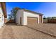 Detached two-car garage showcasing a well-maintained exterior with brown doors and a gravel driveway at 113 W Rawhide Ave, Gilbert, AZ 85233