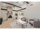 Bright living room featuring a fireplace, wood beams, and an open floor plan at 113 W Rawhide Ave, Gilbert, AZ 85233