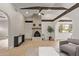 Bright living room featuring a fireplace, wood beams, and an open floor plan at 113 W Rawhide Ave, Gilbert, AZ 85233