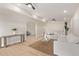 Spacious living room with a plant, neutral furniture, natural lighting, and wood-look floors at 113 W Rawhide Ave, Gilbert, AZ 85233