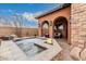 Outdoor water feature and fire feature surrounded by desert landscaping at 12129 W Desert Mirage Dr, Peoria, AZ 85383