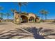 Beautiful community entrance with palm trees and desert landscaping that welcomes residents and guests alike at 12129 W Desert Mirage Dr, Peoria, AZ 85383