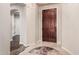 Elegant entryway featuring tile flooring, a wooden door, and arched doorway at 12129 W Desert Mirage Dr, Peoria, AZ 85383