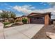 Lovely single-story home with well-maintained landscaping and a two-car garage at 12129 W Desert Mirage Dr, Peoria, AZ 85383