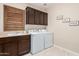 Functional laundry room featuring a sink, cabinets, washer, and dryer at 12129 W Desert Mirage Dr, Peoria, AZ 85383