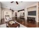 Comfortable living room with hardwood floors, a ceiling fan, and an open floor plan at 12129 W Desert Mirage Dr, Peoria, AZ 85383