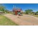 Community playground features a slide and climbing structure set against a backdrop of desert landscape at 12129 W Desert Mirage Dr, Peoria, AZ 85383