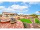 Entertaining backyard has brick paved sitting area, a fire pit, and artificial grass putting green at 13729 E Rancho Laredo Dr, Scottsdale, AZ 85262